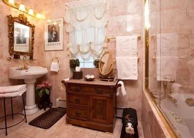 a bathroom with a sink and a shower with a mirror at Beds on Clouds in Windham