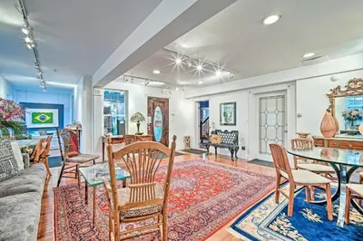 a living room with a table and chairs at Beds on Clouds in Windham