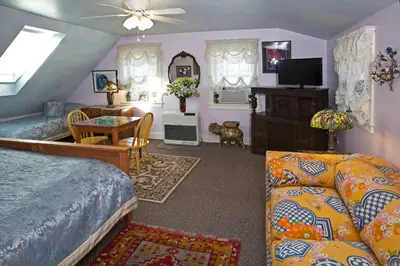 a bedroom with a bed and a living room at Beds on Clouds in Windham