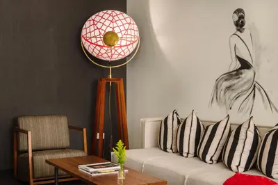 a living room with a couch and a table at Refinery Hotel - New York in New York