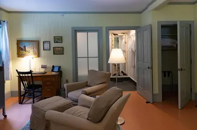 a living room with a couch and chairs and a desk at The Porches Inn at Mass MoCA in North Adams