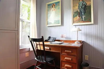 a desk with a chair and a telephone in a room at The Porches Inn at Mass MoCA in North Adams