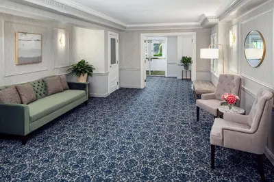 a living room with a couch and a chair at The Madison Hotel in Morristown