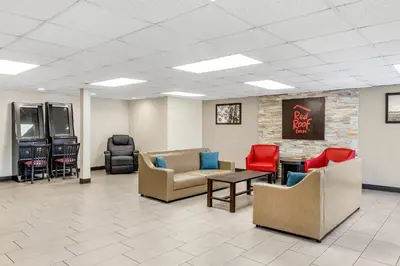 a lobby with couches and chairs and a tv at Red Roof Inn Stroudsburg in Stroudsburg