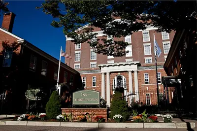 a large brick building with a sign in front of it at Inn at Middletown in Middletown
