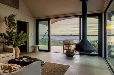 a living room with a view of the water at Collective Retreats Governors Island in New York