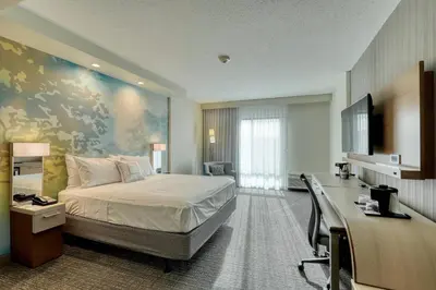 a hotel room with a bed and a desk at Courtyard by Marriott Southington in Southington