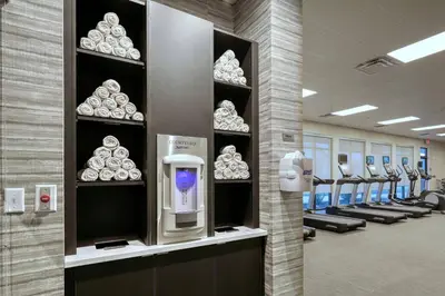 a gym with a row of shelves with a soap dispenser at Courtyard by Marriott Southington in Southington