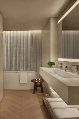 a bathroom with a tub and a sink and a bath tub at The Times Square EDITION New York in New York