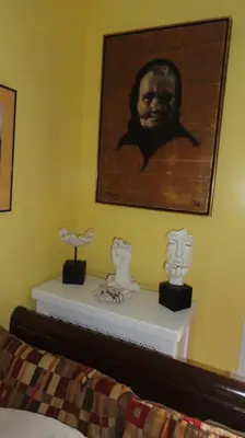 a bedroom with a picture of a man on the wall at The Red Rooster in White Plains