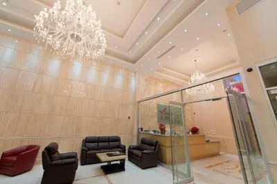 a waiting room with chairs and a chandelier at Asiatic Hotel - Flushing in Queens
