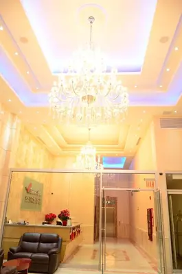 a lobby with a chandelier in a building at Asiatic Hotel - Flushing in Queens