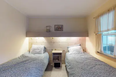 a bedroom with two beds and a desk and a window at Sunderland Guest House in Manchester