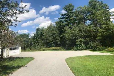 a driveway with grass and trees in the background at Sunderland Guest House in Manchester