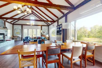 a kitchen and dining room with a wooden table and chairs at Sunderland Guest House in Manchester