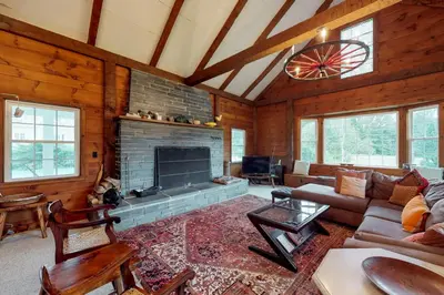 a living room with a fireplace in a cabin at Sunderland Guest House in Manchester