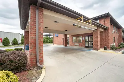 an empty parking lot outside of a brick building at Motel 6-Binghamton, NY in Binghamton