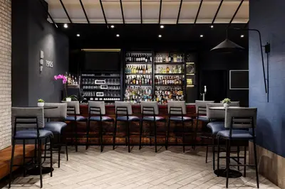 a bar in a restaurant with stools at SpringHill Suites by Marriott New York Manhattan/Times Square South in New York