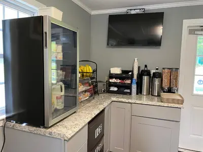a kitchen with a refrigerator with food in it at Villager Motel in Williamstown