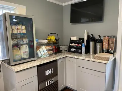 a kitchen counter with a refrigerator with food in it at Villager Motel in Williamstown