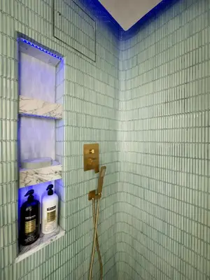 a green tiled bathroom with a shelf with bottles of soap at Shadowcrest in Fleischmanns