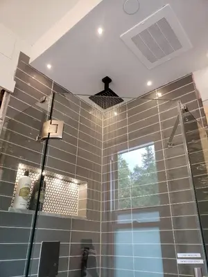 a tiled bathroom with a shower and a window at Shadowcrest in Fleischmanns