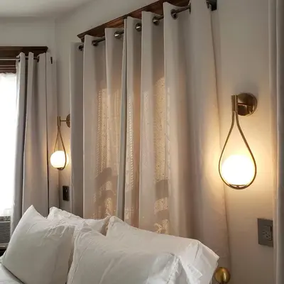 a bedroom with white curtains and a bed with two lights at Shadowcrest in Fleischmanns