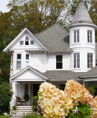 a white house with a tower on top of it at Shadowcrest in Fleischmanns