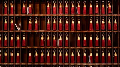 a shelf with lots of red and white bottles at The Bowery Hotel in New York