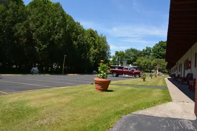 a potted plant sitting on the grass next to a street at The Village Motel in Richfield Springs