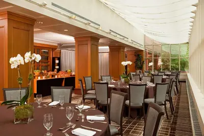 a restaurant with tables and chairs in a room at Hilton Short Hills in Short Hills