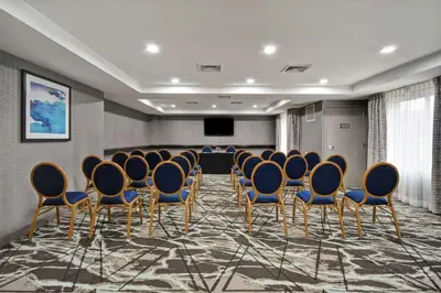 a conference room with chairs and a screen in it at Homewood Suites by Hilton Edgewater-NYC Area in Edgewater