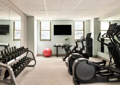 a fitness room with treadmills and cardio machines at Kimpton Theta New York - Times Square by IHG in New York