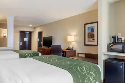 a hotel room with two beds and a television at Comfort Inn & Suites Schenectady - Scotia in Schenectady
