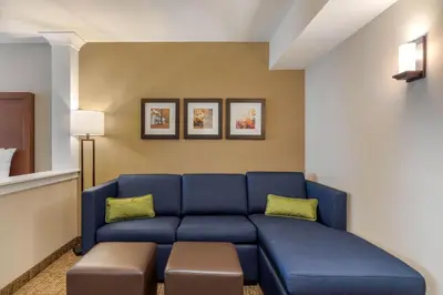 a living room with a blue couch in a room at Comfort Inn & Suites Schenectady - Scotia in Schenectady