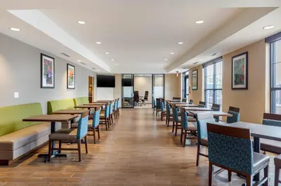 a row of tables and chairs in a restaurant at Comfort Inn & Suites Schenectady - Scotia in Schenectady
