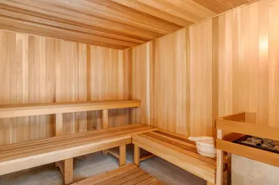 a wooden sauna with wooden shelves in a room at Comfort Inn & Suites Schenectady - Scotia in Schenectady