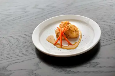 a white plate with food on a table at Hilton Garden Inn Albany Medical Center in Albany