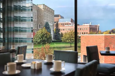 a table with a view of a city from a window at Hilton Garden Inn Albany Medical Center in Albany