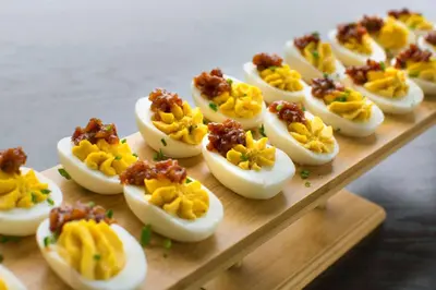 a bunch of deviled eggs on a wooden board at Hilton Garden Inn Albany Medical Center in Albany