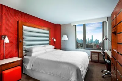 a hotel room with a large bed and a window at The Chelsean New York in New York