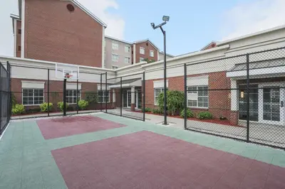 an empty basketball court in front of a building at Homewood Suites by Hilton Albany in Albany
