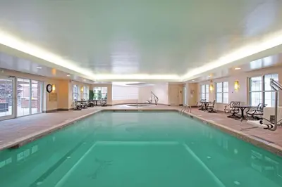 a large swimming pool in a hotel room at Homewood Suites by Hilton Albany in Albany