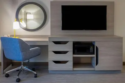 a room with a tv and a chair and a mirror at Hampton Inn Harriman Woodbury in Central Valley