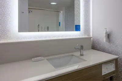 a bathroom with a sink and a mirror at Hampton Inn Harriman Woodbury in Central Valley