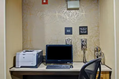 a desk with a computer and a printer on it at Hampton Inn Albany-Wolf Road in Albany