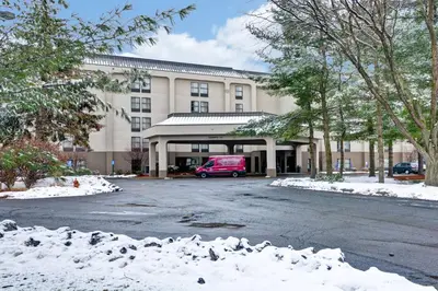 a building with a red van parked in front of it at Hampton Inn Albany-Wolf Road in Albany