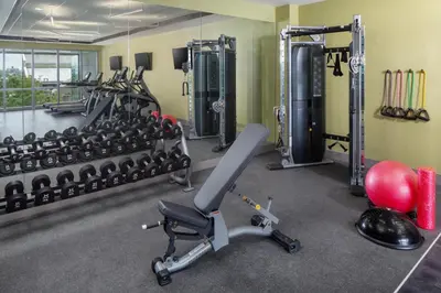 a gym with a lot of exercise equipment at Hotel Indigo Flushing - LaGuardia in Queens