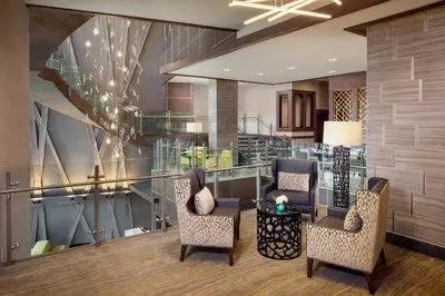 a lobby with two chairs and a table at Hotel Indigo Flushing - LaGuardia in Queens