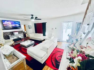 a living room with white furniture and a flat screen tv at Fearlessrose vacation Rental 89 in Springfield